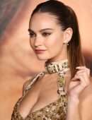 Lily James Cleavage in a Golden Dress at “Pam & Tommy” Finale Premiere in Los Angeles