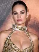 Lily James Cleavage in a Golden Dress at “Pam & Tommy” Finale Premiere in Los Angeles