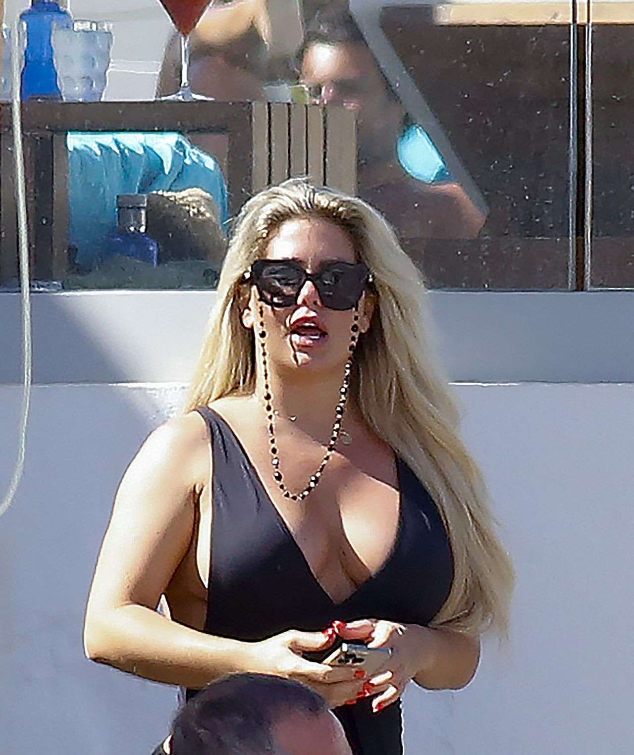 Bianca Gascoigne in a Black Swimsuit at Ibiza’s Cala de Bou Beach